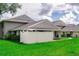 Exterior shot showcases well-kept townhomes with fresh landscaping and a manicured lawn at 4438 Pinebark Ave # 4, Orlando, FL 32811