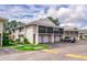 Exterior view of well-maintained townhomes, featuring attached garages, screened patios, and tidy landscaping at 4438 Pinebark Ave # 4, Orlando, FL 32811