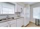 Bright kitchen features stainless steel sink, white appliances, and tile backsplash at 4438 Pinebark Ave # 4, Orlando, FL 32811