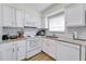 Bright white kitchen boasts stainless steel appliances, granite counters, and ample cabinet space at 4438 Pinebark Ave # 4, Orlando, FL 32811
