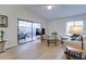 Bright living room boasts wood floors and sliding door access to a screened patio at 4438 Pinebark Ave # 4, Orlando, FL 32811