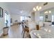 Bright living room and dining area with a modern light fixture and light wood floors at 4438 Pinebark Ave # 4, Orlando, FL 32811
