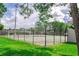Community tennis court surrounded by lush green landscaping, perfect for sports enthusiasts at 4438 Pinebark Ave # 4, Orlando, FL 32811