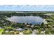 Scenic aerial view of homes near lakes showcasing lush trees, neighborhoods, and city skyline in the distance at 4825 Waterwitch Point Dr, Orlando, FL 32806