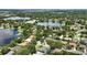 Scenic aerial view of homes near lakes showcasing lush trees, neighborhoods, and city skyline in the distance at 4825 Waterwitch Point Dr, Orlando, FL 32806