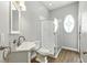 Well-lit bathroom with an enclosed shower, featuring modern fixtures and a stylish oval window at 4825 Waterwitch Point Dr, Orlando, FL 32806