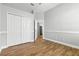 Bedroom featuring hardwood floors, ample closet space, and neutral paint, offering room to personalize at 4825 Waterwitch Point Dr, Orlando, FL 32806