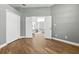 Inviting bedroom with hardwood flooring and an open doorway leading to the home's interior at 4825 Waterwitch Point Dr, Orlando, FL 32806