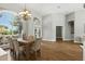 Open dining area with wood floors, a chandelier, and large windows providing plenty of natural light at 4825 Waterwitch Point Dr, Orlando, FL 32806