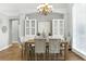 Bright dining room with a wooden table set for six, built-in cabinets, and large windows at 4825 Waterwitch Point Dr, Orlando, FL 32806