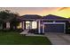 Charming single-story home featuring a two-car garage, well-maintained lawn, and arched entryway with decorative columns at 4825 Waterwitch Point Dr, Orlando, FL 32806