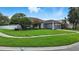 Attractive single-story home boasting a lush green lawn, landscaped garden, and a two-car garage at 4825 Waterwitch Point Dr, Orlando, FL 32806