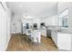 Open kitchen with stainless steel appliances, white cabinetry, granite countertops, and barstool seating at 4825 Waterwitch Point Dr, Orlando, FL 32806
