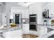 Well-equipped kitchen with granite countertops, stainless steel appliances, and white cabinets at 4825 Waterwitch Point Dr, Orlando, FL 32806