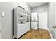 Well-organized laundry room with stacked washer/dryer and a bright white storage cabinet at 4825 Waterwitch Point Dr, Orlando, FL 32806
