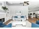 Spacious living room with modern decor, a fireplace, and an open view of the kitchen and dining area at 4825 Waterwitch Point Dr, Orlando, FL 32806