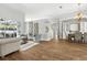 Bright living room with hardwood floors, stylish furniture, and sliding doors to the outdoor pool area at 4825 Waterwitch Point Dr, Orlando, FL 32806