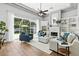 Inviting living room with a fireplace, built-in bookshelves, and large windows overlooking the backyard at 4825 Waterwitch Point Dr, Orlando, FL 32806
