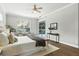 Bright main bedroom with sliding glass doors to pool area, bench, and wood-look floors at 4825 Waterwitch Point Dr, Orlando, FL 32806