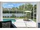Screened pool area featuring a patio dining set and lush landscaping at 4825 Waterwitch Point Dr, Orlando, FL 32806