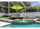 Beautiful in-ground pool with a tranquil water feature and an umbrella-shaded lounge area at 4825 Waterwitch Point Dr, Orlando, FL 32806