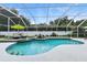 Sparkling pool in screened enclosure featuring lush landscaping, and seating, perfect for relaxation at 4825 Waterwitch Point Dr, Orlando, FL 32806