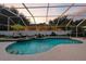 Screened in pool area featuring lounge chairs, small fountain, and verdant landscaping around the perimeter at 4825 Waterwitch Point Dr, Orlando, FL 32806