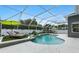 In-ground pool with lush landscaping, water feature and lounge chairs in screened-in lanai at 4825 Waterwitch Point Dr, Orlando, FL 32806