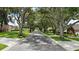 Shaded street with mature trees lining the road, offering a peaceful neighborhood setting at 4825 Waterwitch Point Dr, Orlando, FL 32806