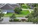 Exterior view of the home showcasing the driveway and landscaping, situated near the community's entrance sign at 4825 Waterwitch Point Dr, Orlando, FL 32806
