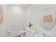 Powder room features a modern white vanity, round mirror, and accessible grab bar at 5202 Orchard Oriole Loop, Bartow, FL 33830