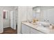 Bright bathroom featuring double sinks with white cabinets, decorative items, and a view into the shower and toilet areas at 5202 Orchard Oriole Loop, Bartow, FL 33830
