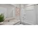 Bright bathroom featuring a new shower/bathtub combo, mirror, decor and a white sink with a quartz countertop at 5202 Orchard Oriole Loop, Bartow, FL 33830