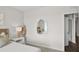 Bright bedroom view featuring a bed, side table with lamp, decor, and doorway at 5202 Orchard Oriole Loop, Bartow, FL 33830