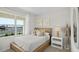 Cozy bedroom featuring a wooden bed frame, decorative pillows, and a bright window view at 5202 Orchard Oriole Loop, Bartow, FL 33830
