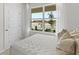 Bedroom view showcasing a bed with decorative pillows, a window, and a white door at 5202 Orchard Oriole Loop, Bartow, FL 33830
