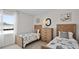 Bright bedroom featuring two twin beds, wooden headboards, a dresser, and soccer-themed decor at 5202 Orchard Oriole Loop, Bartow, FL 33830