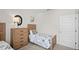 Well-lit bedroom with a twin bed, wooden dresser, soccer art, and a white door at 5202 Orchard Oriole Loop, Bartow, FL 33830