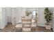 Bright dining area features wood floors, round white table with 4 chairs, and indoor plants for a fresh look at 5202 Orchard Oriole Loop, Bartow, FL 33830