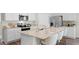 Modern kitchen with stainless steel appliances, white cabinetry, stone countertops and stylish fixtures at 5202 Orchard Oriole Loop, Bartow, FL 33830