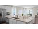 Bright open concept kitchen island with stainless steel appliances, sink, and barstool seating at 5202 Orchard Oriole Loop, Bartow, FL 33830