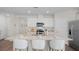 Open-concept kitchen with stainless steel appliances, modern cabinetry, large island with barstool seating at 5202 Orchard Oriole Loop, Bartow, FL 33830