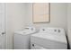 Laundry area with side by side white Whirlpool washer and dryer at 5202 Orchard Oriole Loop, Bartow, FL 33830