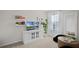 Bright living room featuring shelving, decor, and a window with curtains, with a nice plant next to the window at 5202 Orchard Oriole Loop, Bartow, FL 33830