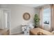 Bright office showcasing a white console table, wooden desk, plant, and round mirror at 5202 Orchard Oriole Loop, Bartow, FL 33830
