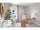 Well-lit office featuring a desk, chair, plant, mirror, and window with curtains at 5202 Orchard Oriole Loop, Bartow, FL 33830