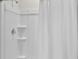 Bright shower featuring a new shower head, built-in shelves, and a new white shower curtain at 5202 Orchard Oriole Loop, Bartow, FL 33830