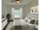 Comfortable bedroom offering a plush bed, ceiling fan, and windows providing natural light at 534 S Adelle Ave, Deland, FL 32720