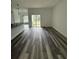 Spacious living area boasting hardwood floors and sliding door access to the backyard at 534 S Adelle Ave, Deland, FL 32720