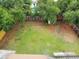 Aerial view of the backyard area featuring large green space and wooden fence around at 5615 Arundel Dr, Orlando, FL 32808